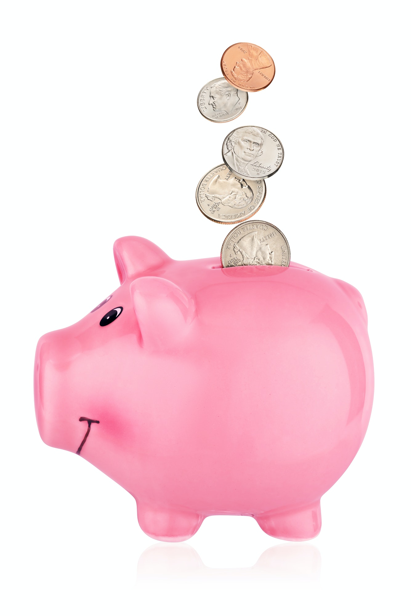 Pink piggy bank with falling coins isolated on white background